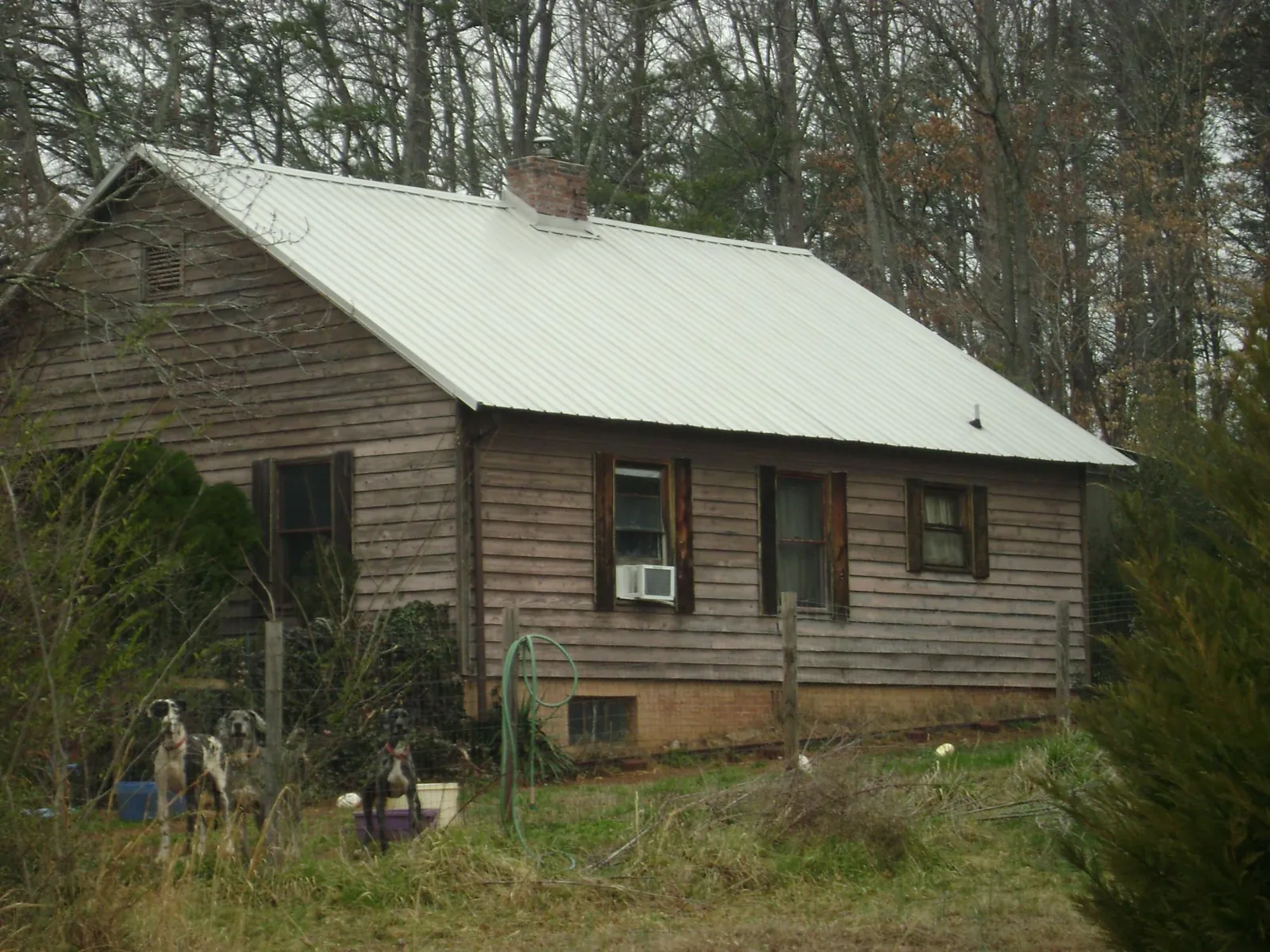 White metal roof on an old wood sided farmhouse, from a Metal Roof Installation job in Swainsboro